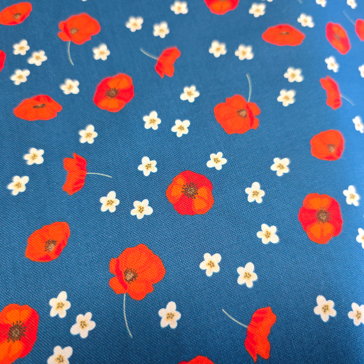 Craft Cotton Company Scattered Poppies on Blue Fabric - 112cm Wide