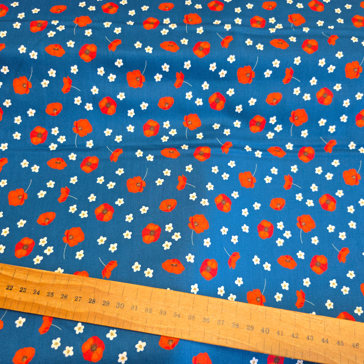Craft Cotton Company Scattered Poppies on Blue Fabric - 112cm Wide